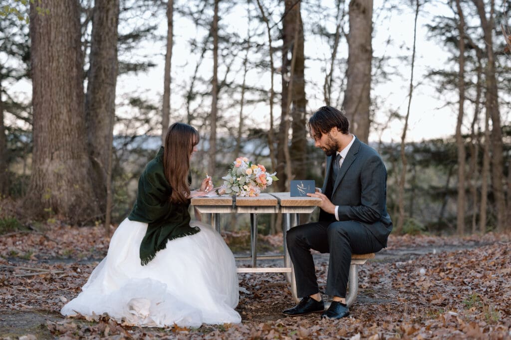 Couple writing vows at a picnic bench in Cuyahoga Valley National Park.
