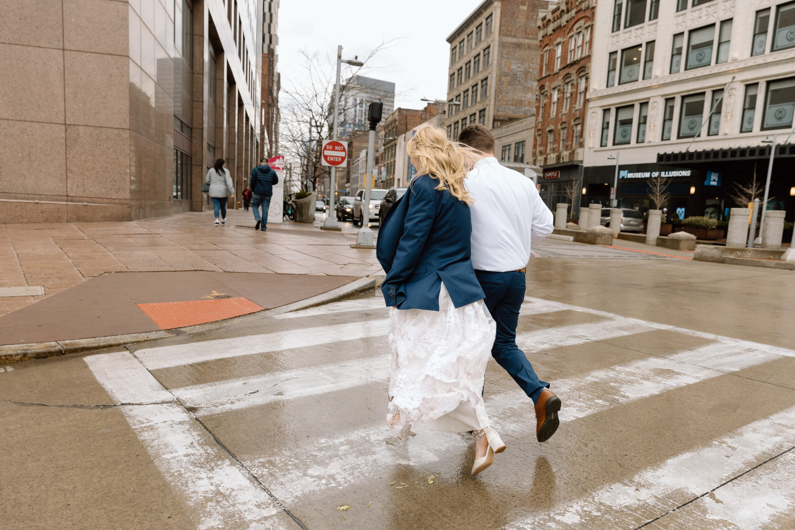 Couple running on wet streets in Cleveland.