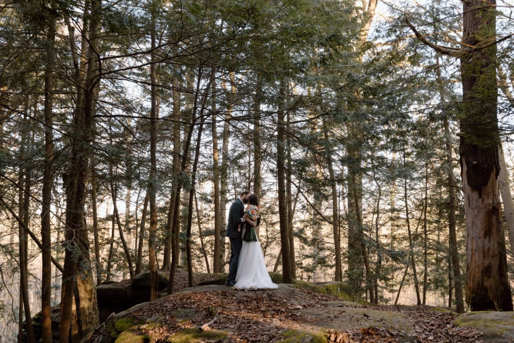 Couple kissing on top of rock formations at the Ledges trail in Cuyahoga Valley National Park.
