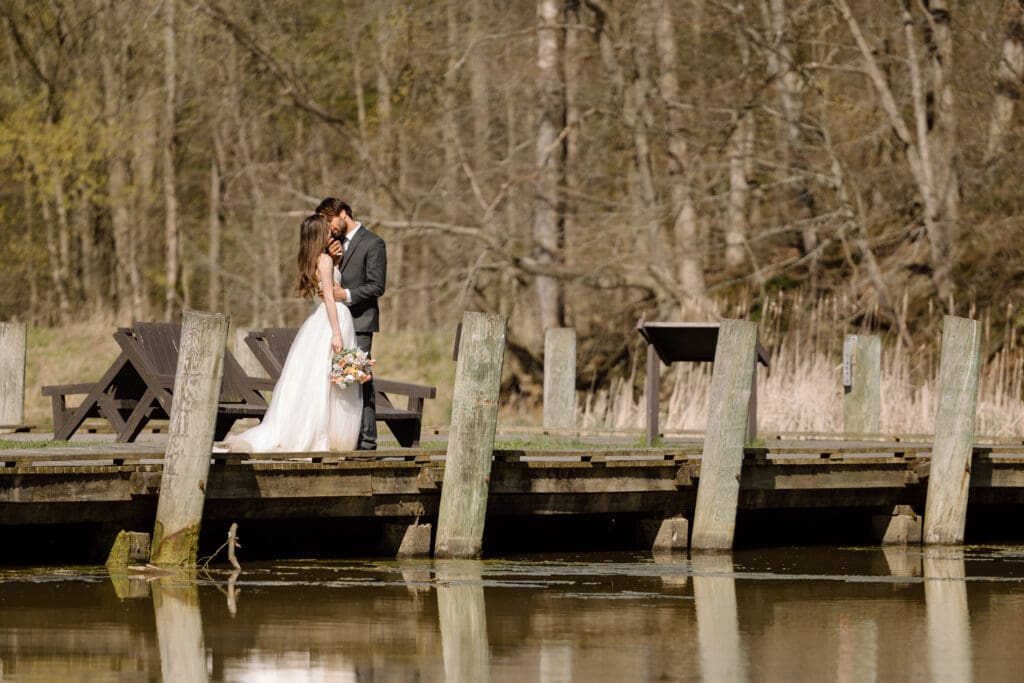 Eloping couple embracing on a dock in Cuyahoga Valley National Park.