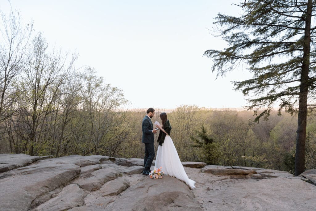 Elopement couple reading vows at Cuyahoga Valley National Park's overlook. 