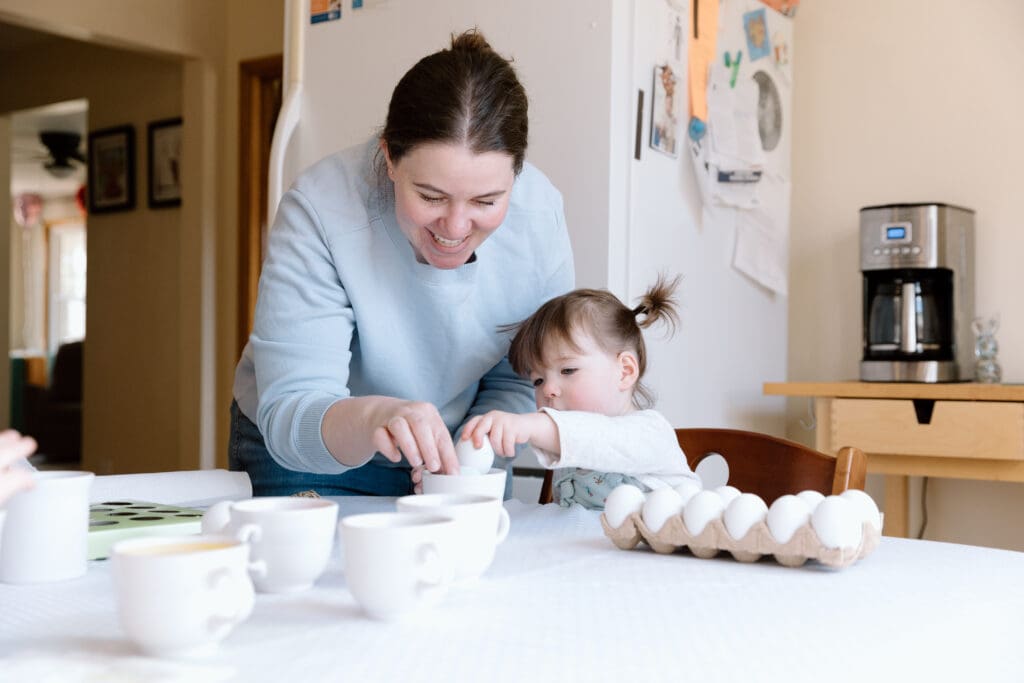 Mother and daughter decorating Easter eggs.