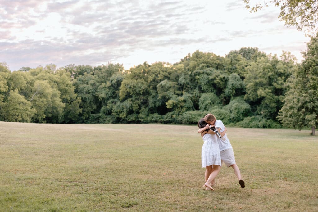 Couple embracing while holding an ultrasound.