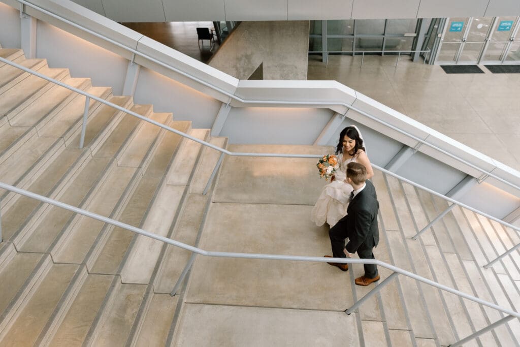 Couple walking up the stairs of the Akron Art Museum.