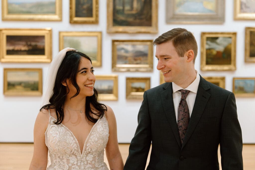 Couple walking in front of a gallery in the Akron Art Museum.