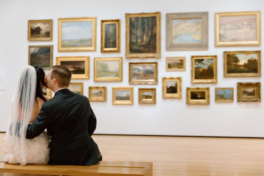 Couple sitting on a bench in front of an gallery in the Akron Art Museum.