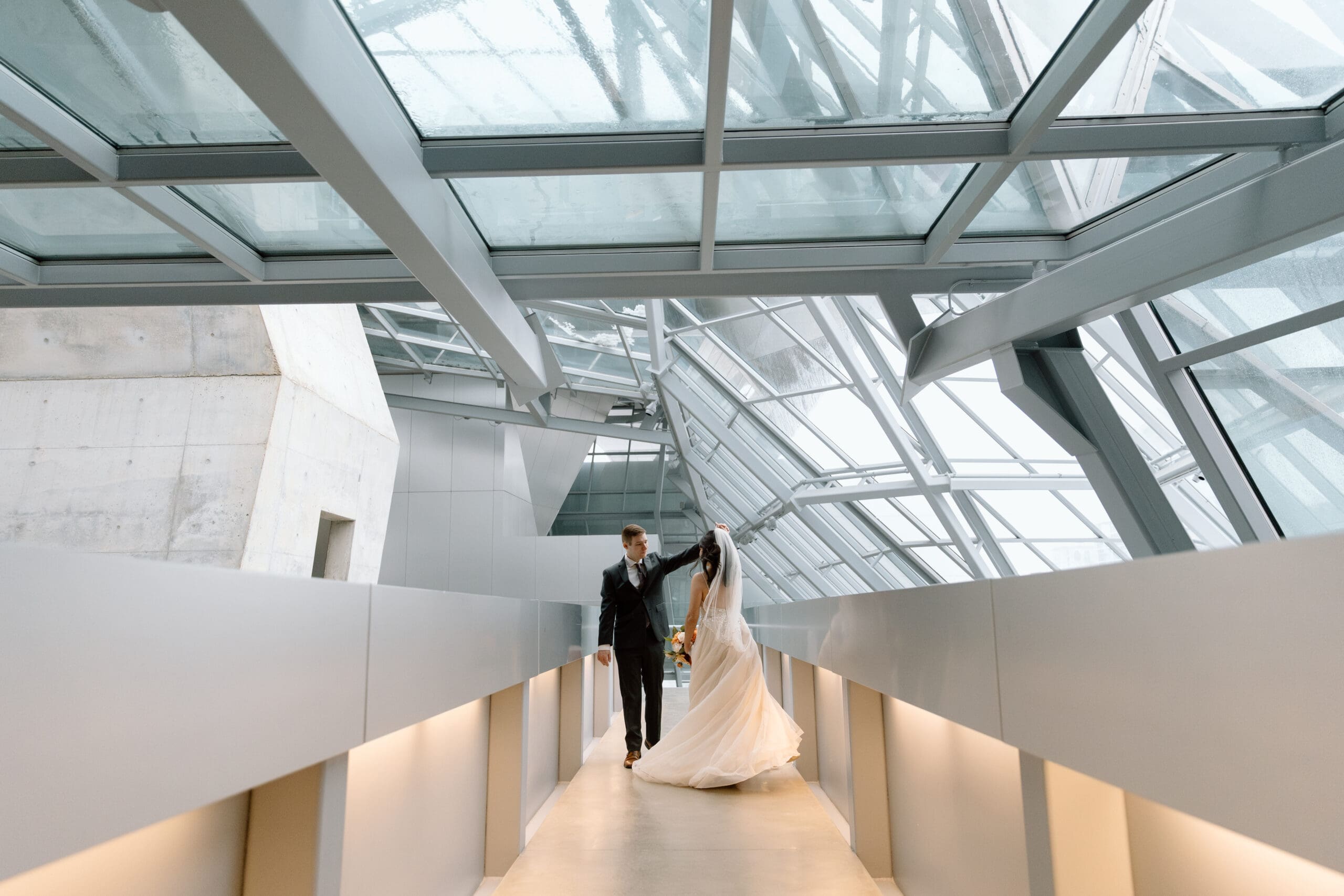 Couple dancing in the walkway of the atrium of the Akron Art Museum.