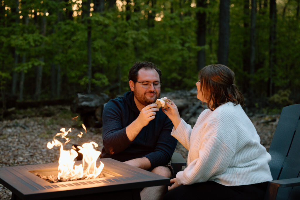Elopement couple toasting with S'mores outside their Airbnb.