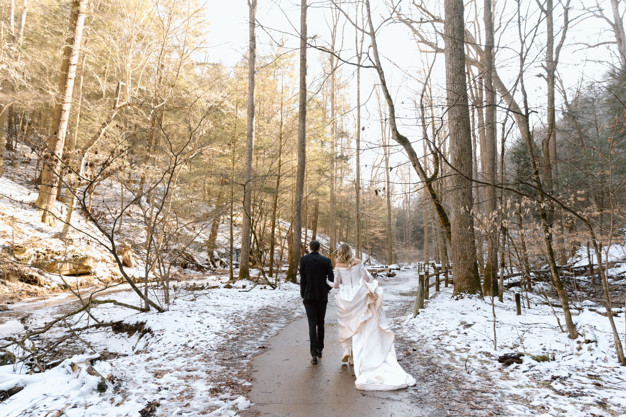 Couple walking back after an elopement in Ash Cave.