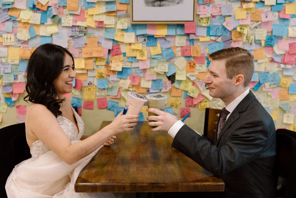 Couple toasting with bubble tea during a winter elopement near Akron, Ohio.