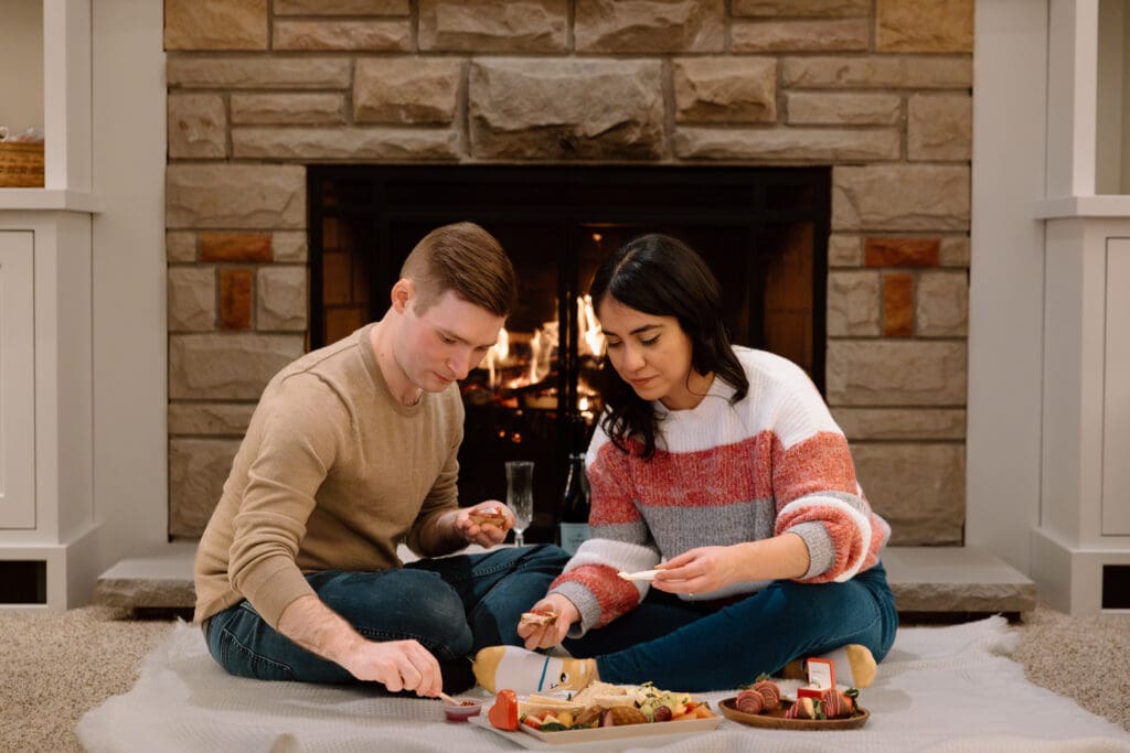 Couple eating from a charcuterie board.