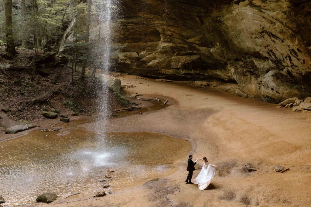 Elopement couple dancing by the waterfall at Ash Cave