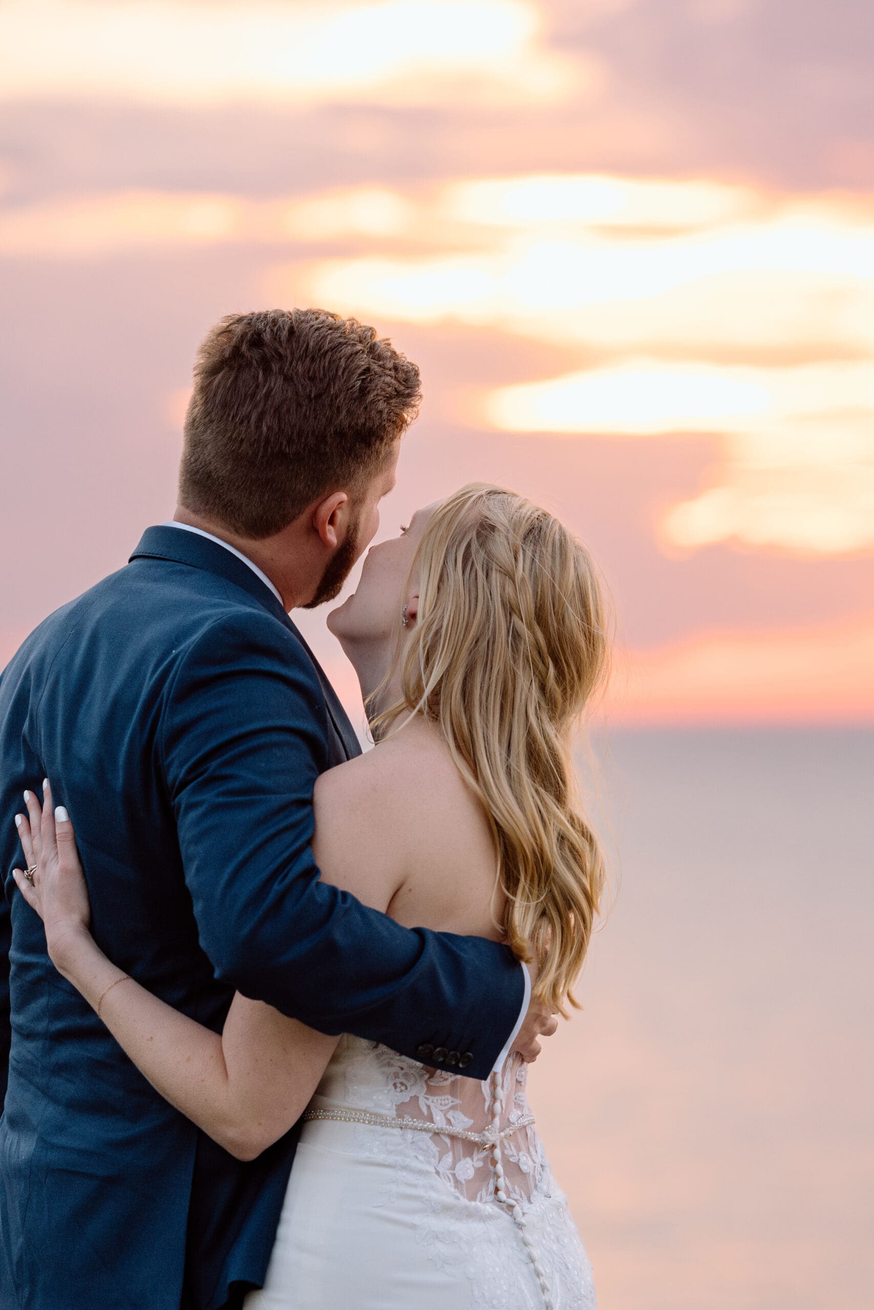 Couple embracing and watching the sunset on Lake Erie.