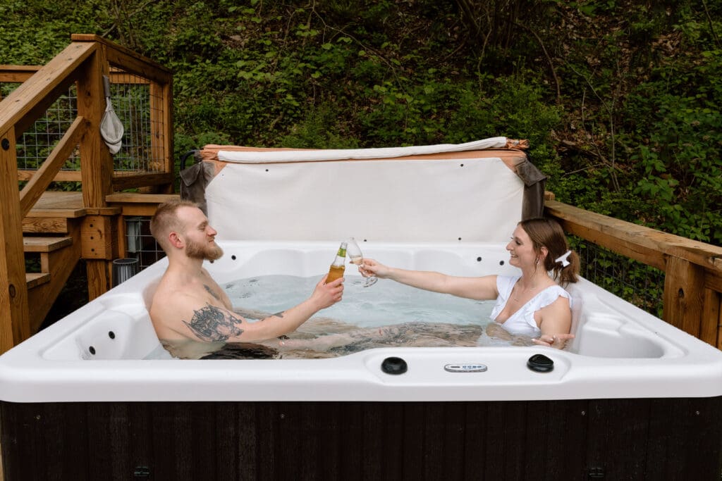 Couple toasting drinks in a hot tub. 