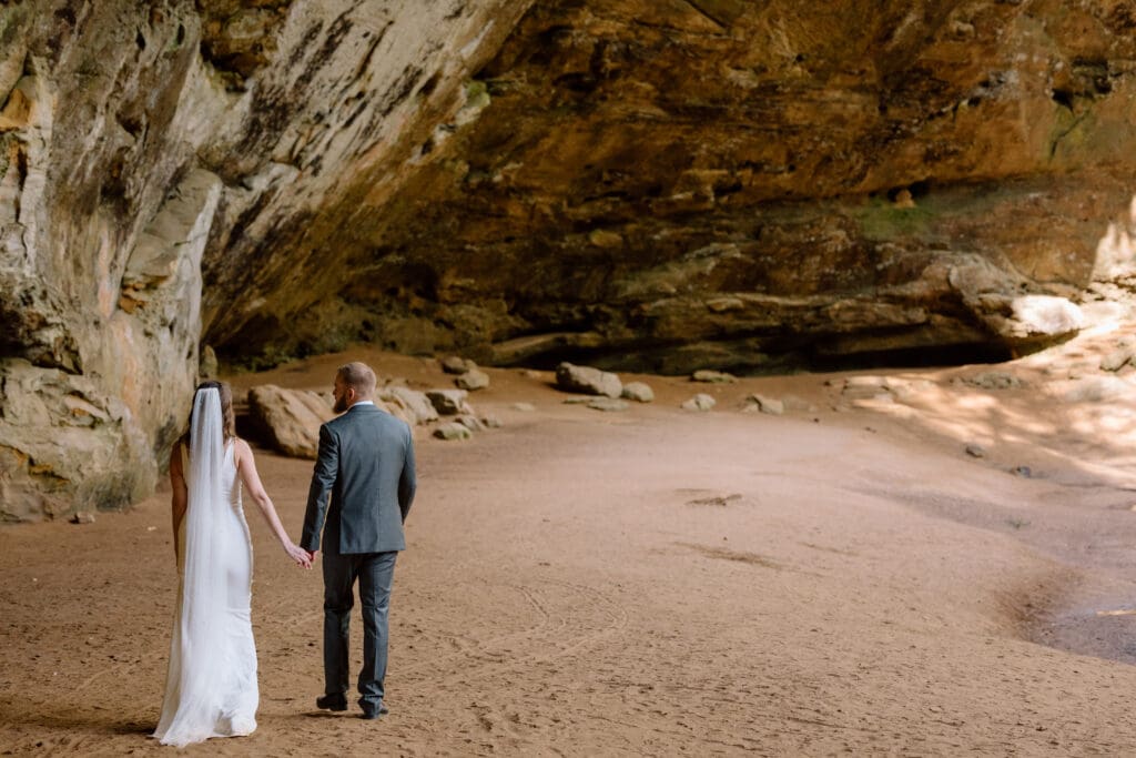 Couple walking under the recess cave at Ash Cave.