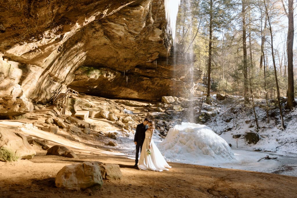 Couple in front of frozen waterfall in Ash Cave.