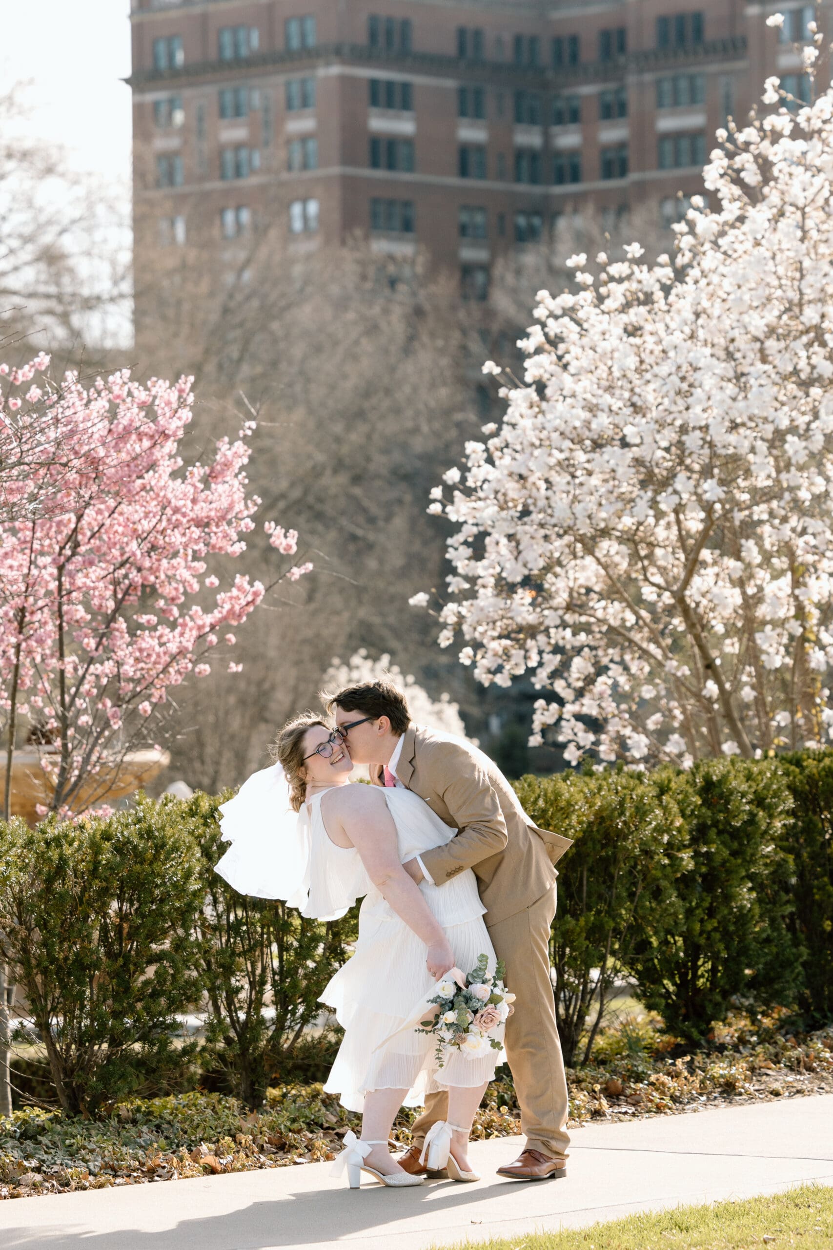 Couple embracing during spring elopement at Wade Lagoon in Cleveland, Ohio.