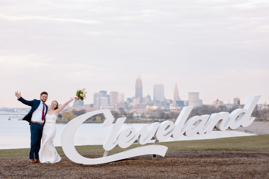 Elopement couple standing next to the Cleveland sign.