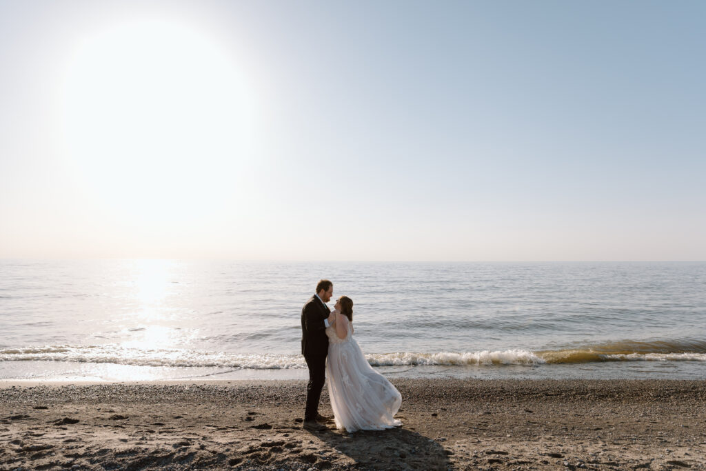 Elopement couple dancing on the shore of Lake Erie.