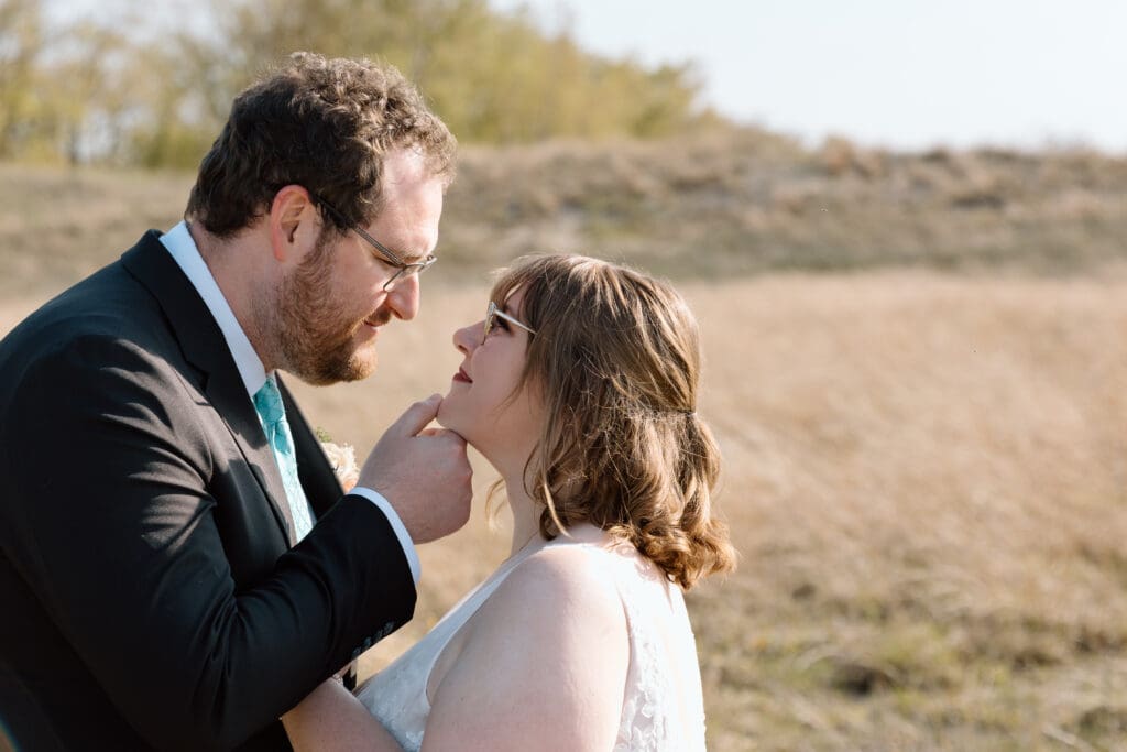 Eloping couple about to kiss at Headlands Beach State Park.