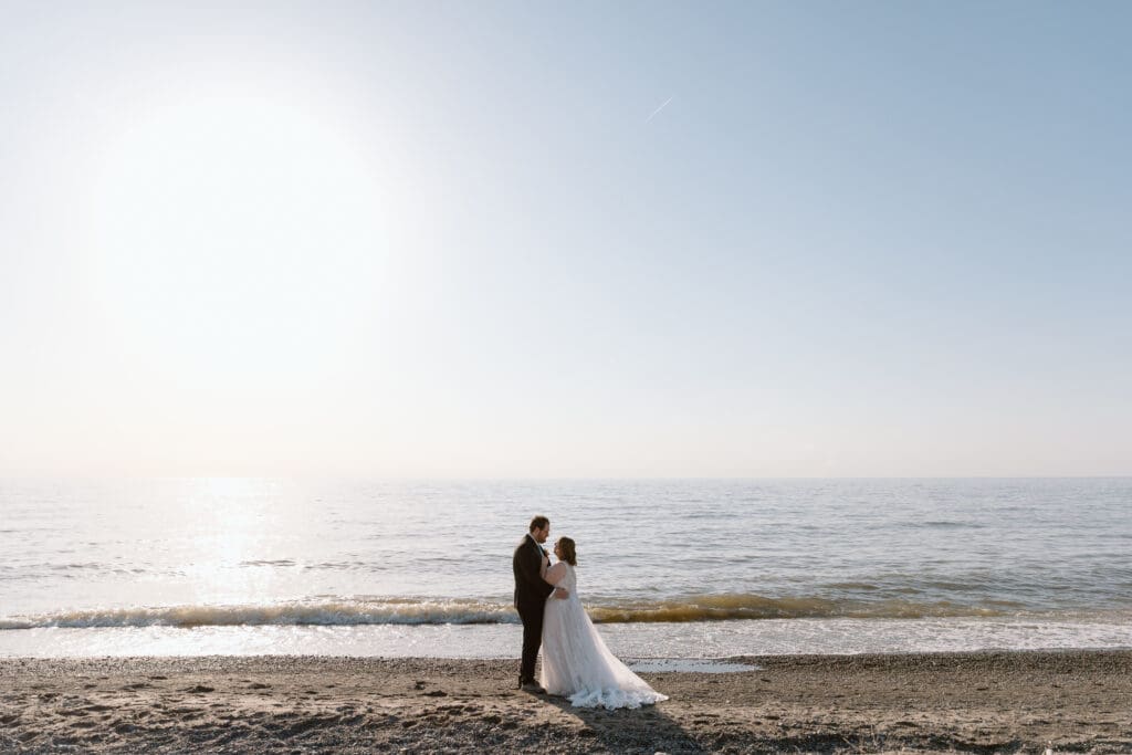 Elopement couple dancing on Lake Erie's Headlands Beach.