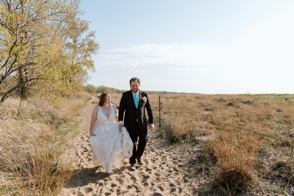 Eloping couple walking in Headlands Beach State Park.