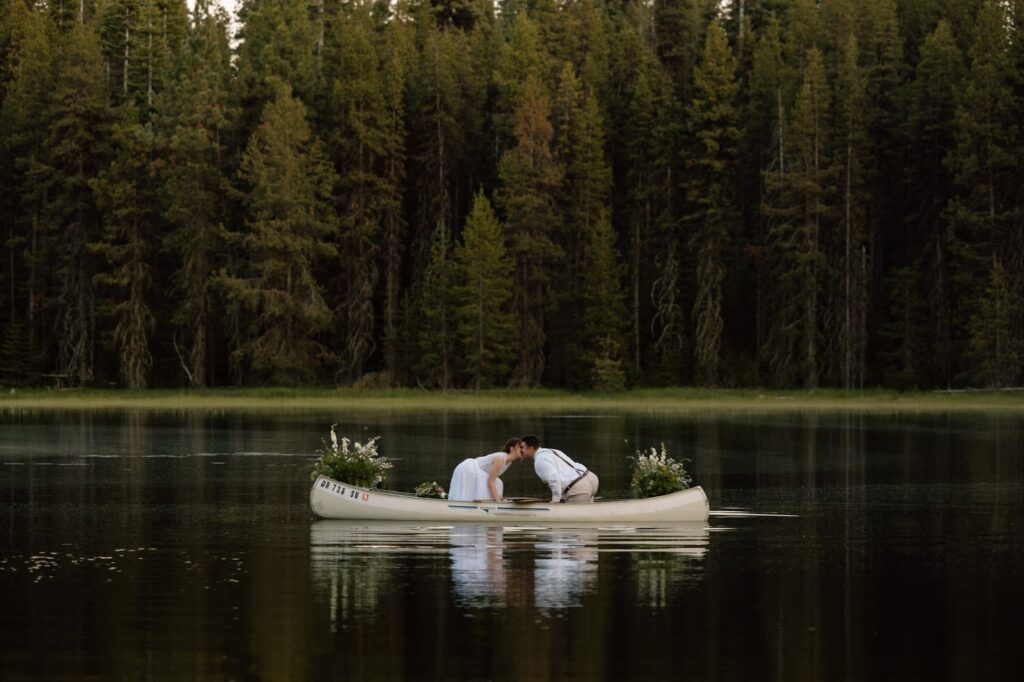 Couple kissing in a canoe in a lake in Central Oregon.