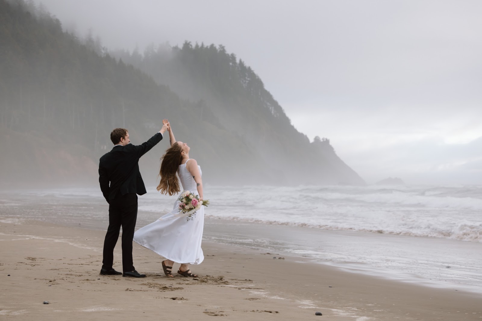 Elopement couple dancing on the Oregon Coast.
