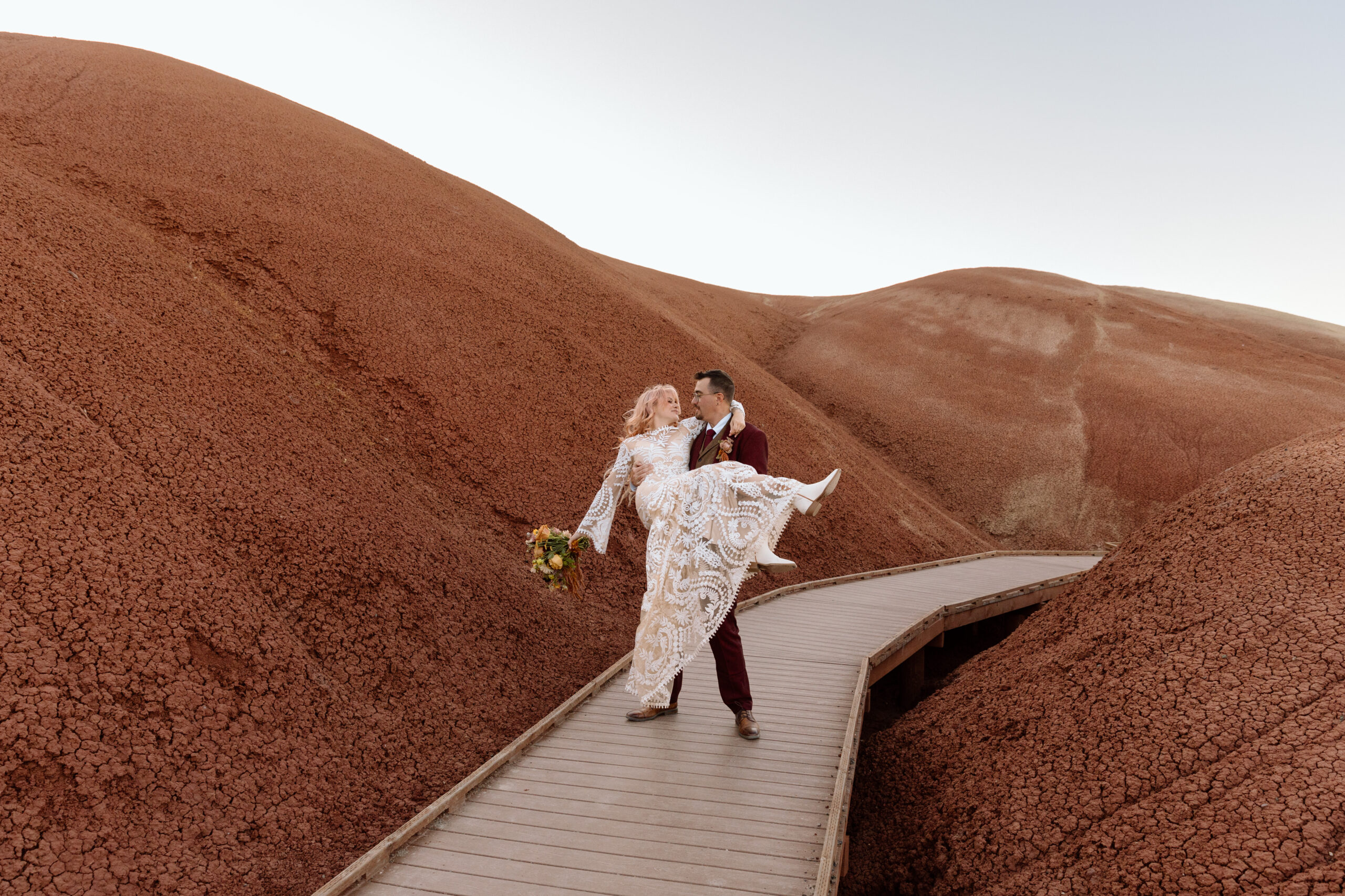 Couple spinning on a boardwalk in Painted Hills.