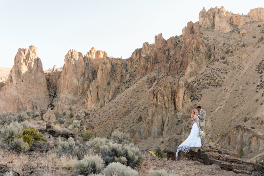 Couple embracing on a cliff's edge at Smith Rock.