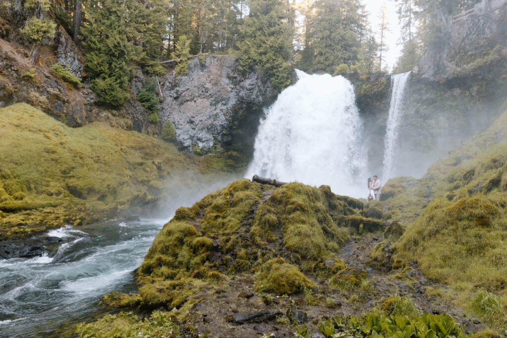 Couple in front of a waterfall in Central Oregon.