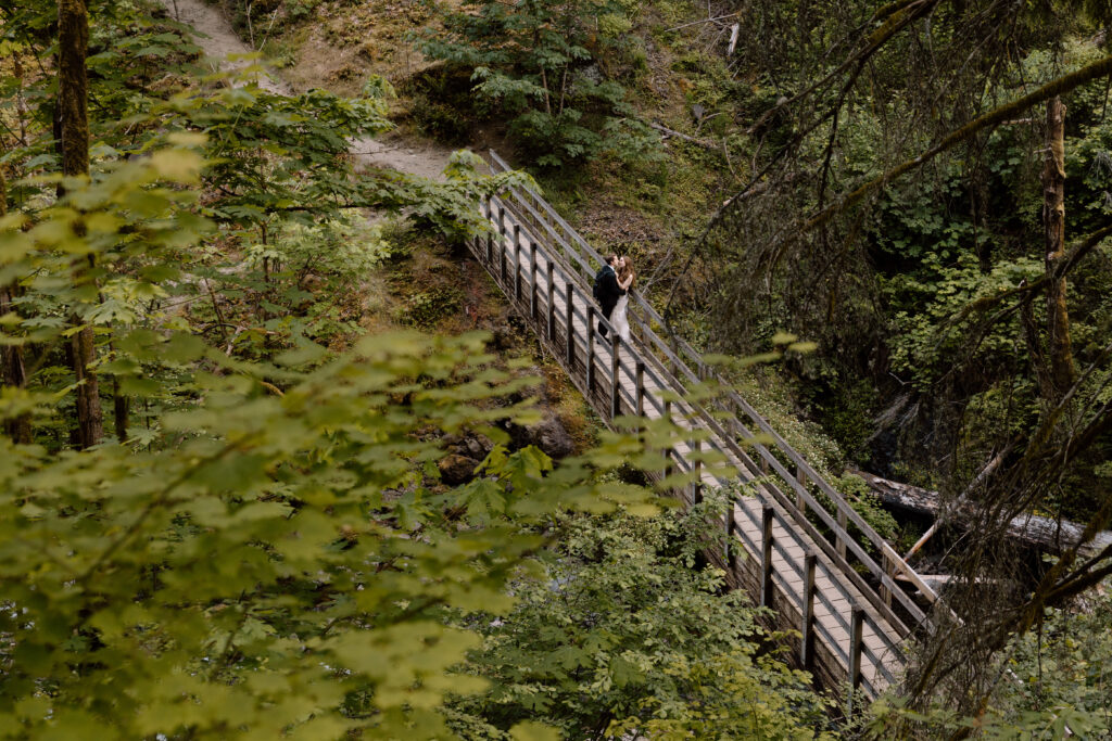Couple kissing on a bridge in the Columbia River Gorge.