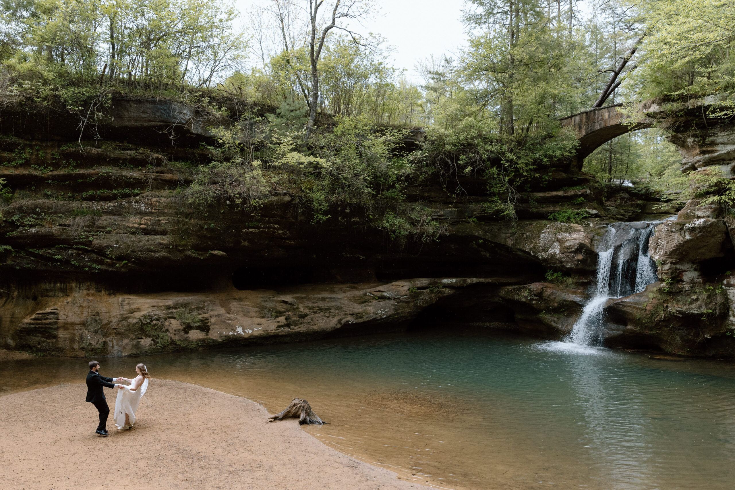 Elopement couple dancing and spinning at Old Man's cave in front of the upper waterfall.