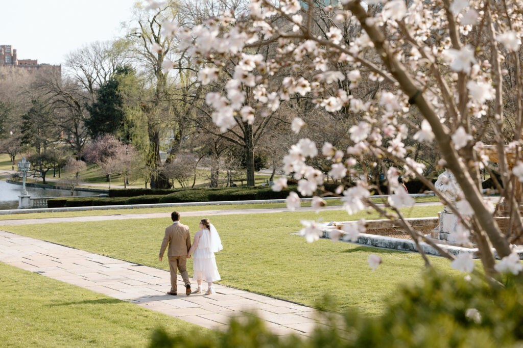 Couple walking surrounded by blossoms in Cleveland.