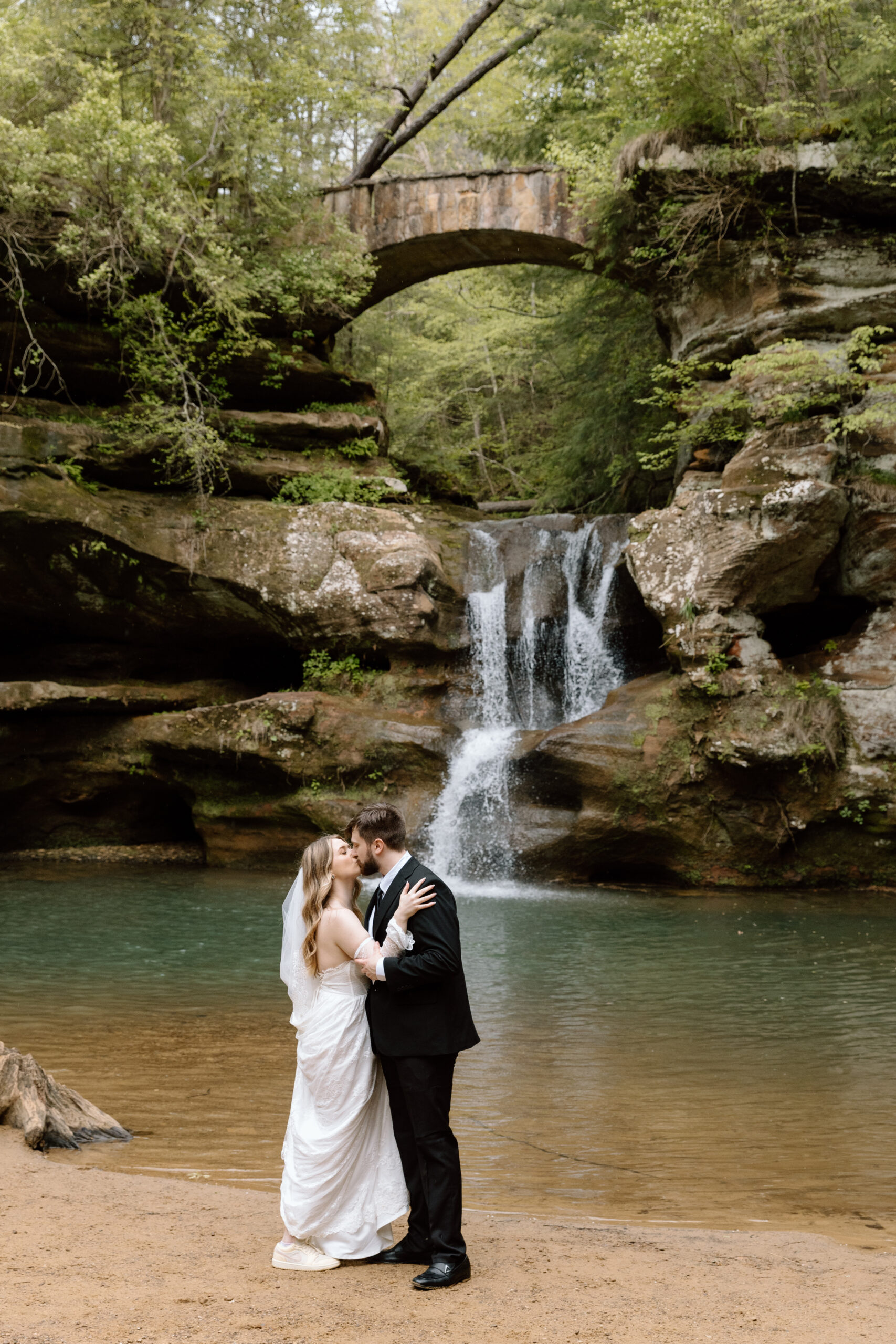 Couple embracing in front of Old Man's Cave waterfall.