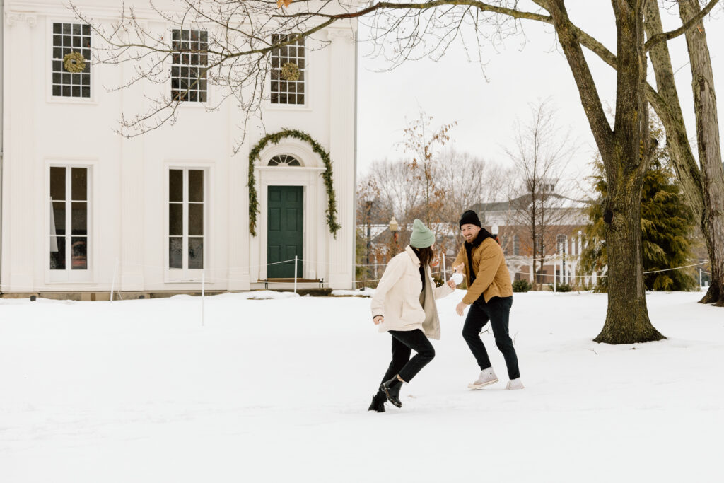 M and R having a snow ball fight in front of the museum.