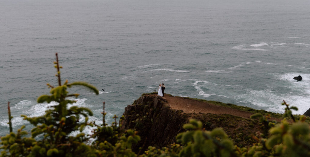 Elopement couple embracing on a far off cliff.