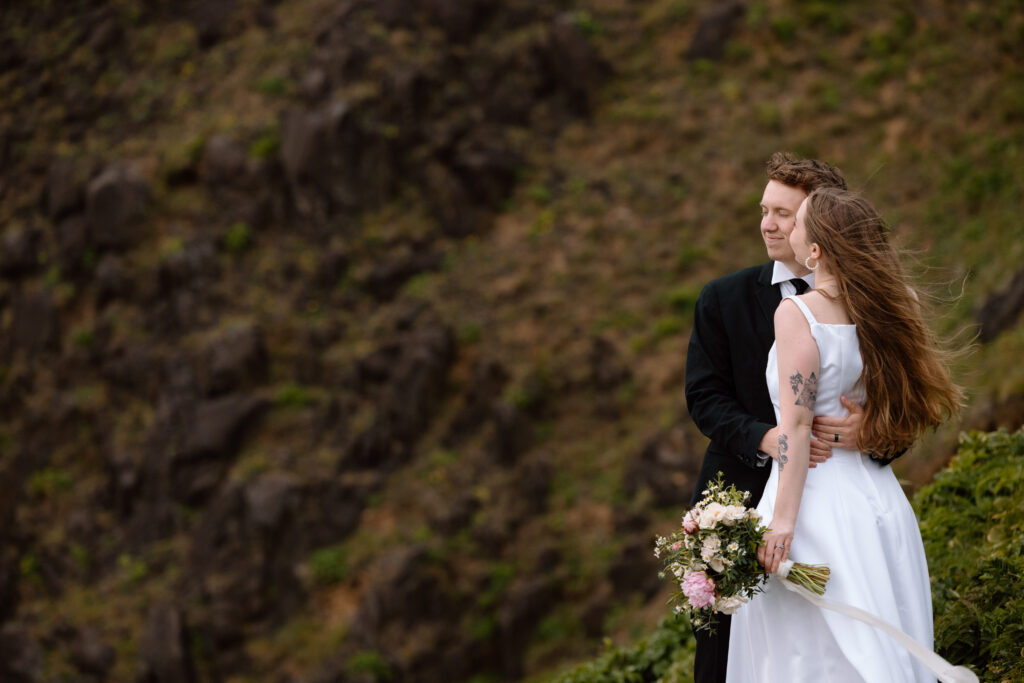 Couple embracing on a cliff.