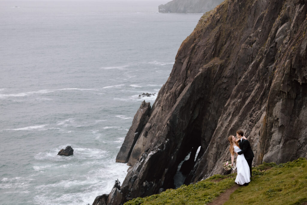 Couple embracing on the cliffs of the Oregon Coast.