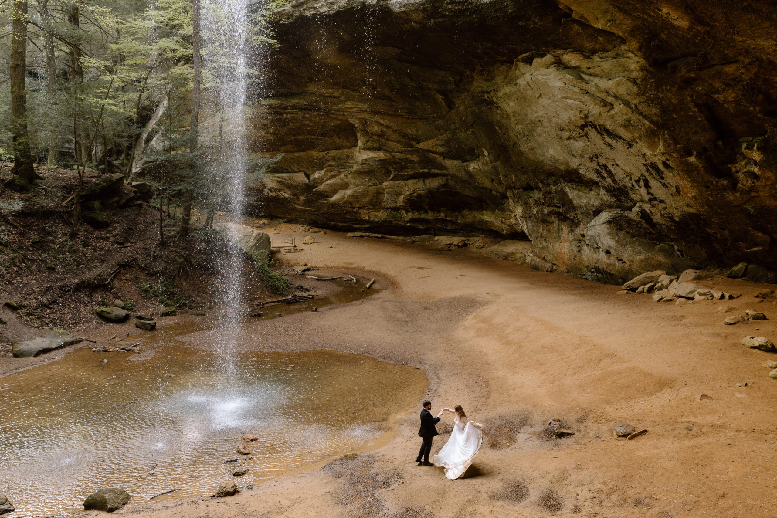 Couple dancing next to the waterfall in Ash Cave.