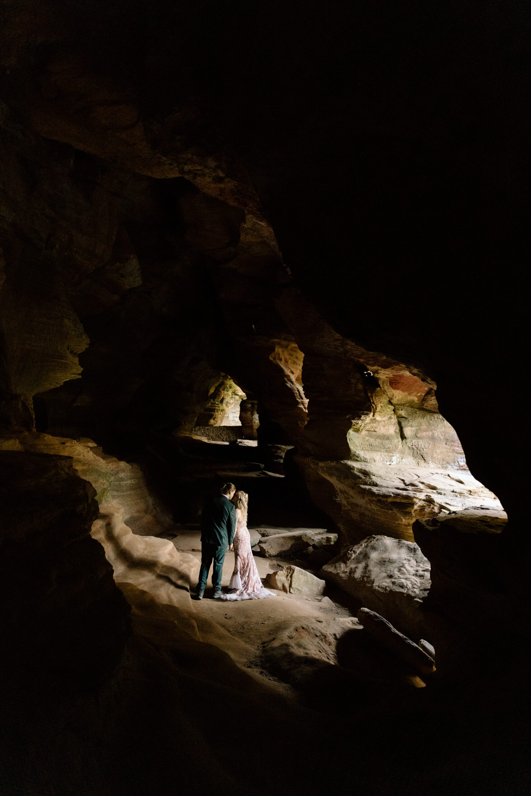 Couple kissing in Rockhouse Cave in Hocking Hills State Park in Ohio.