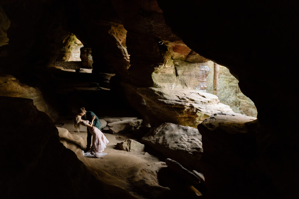 Elopement couple kissing in Rock House cave.