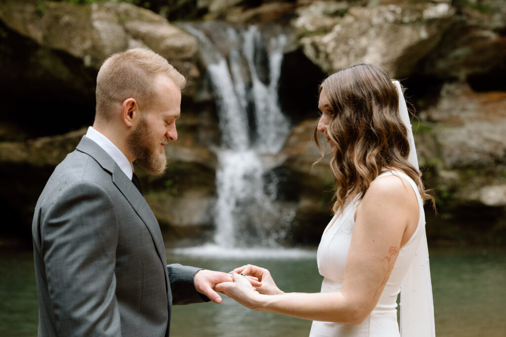 Bride and groom exchanging rings during an elopement at Old Man's Cave.