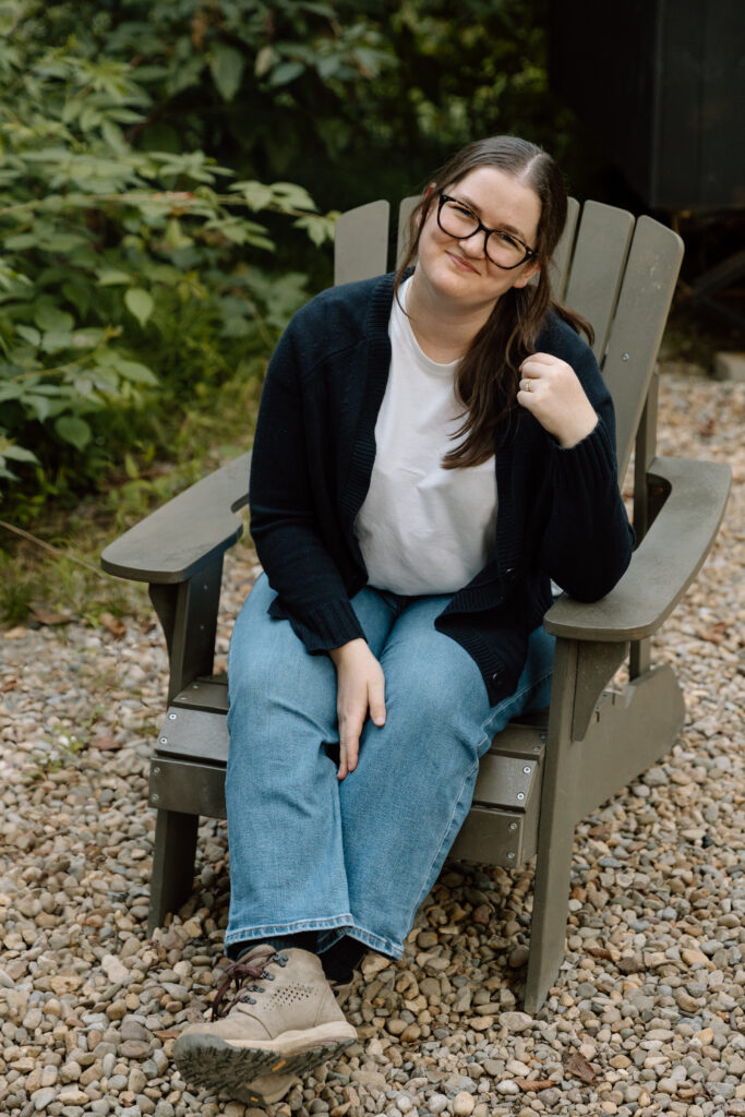 Desiree sitting in an Adirondack chair.