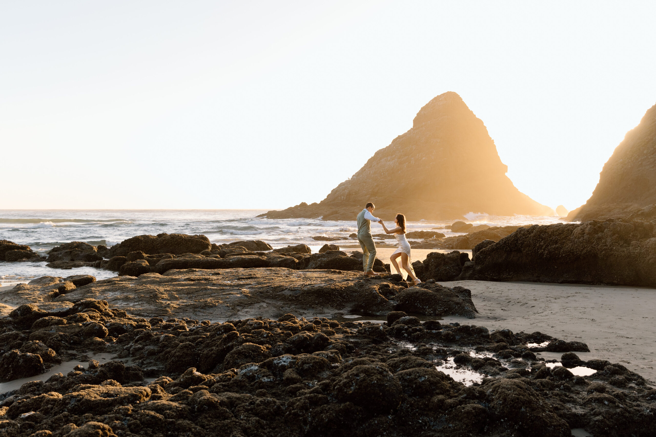 Couple walking on the rocks on an Oregon Coast Beach.