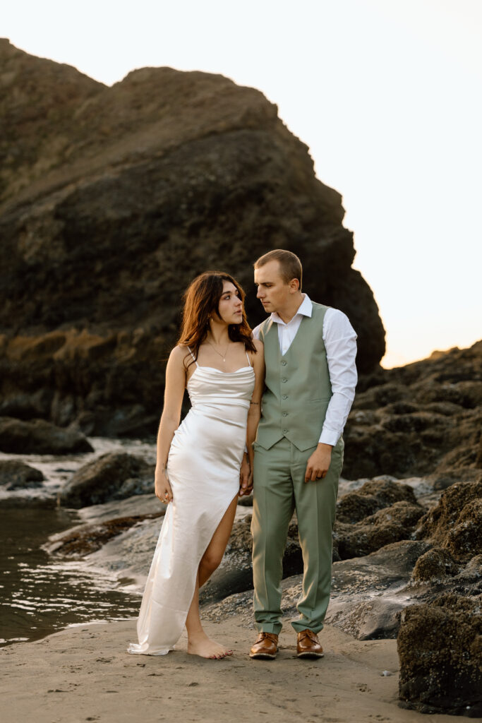 Bride leaning on groom as they stand beside each other.