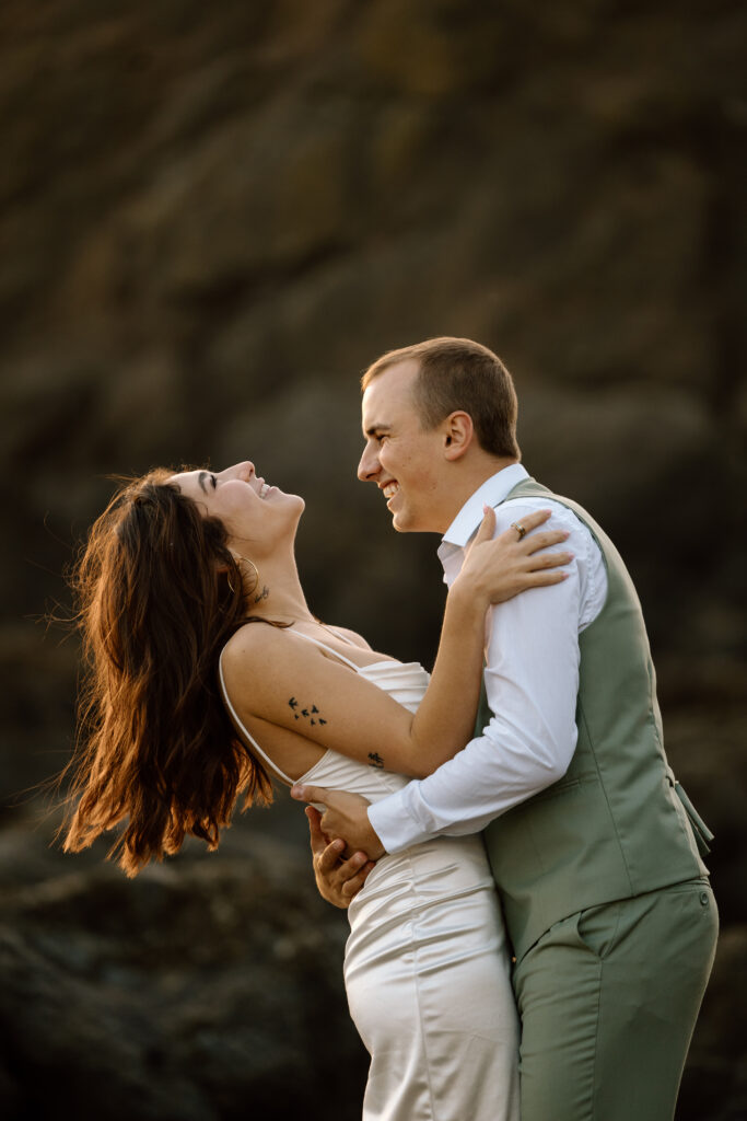 Bride leaning back while hugging groom.