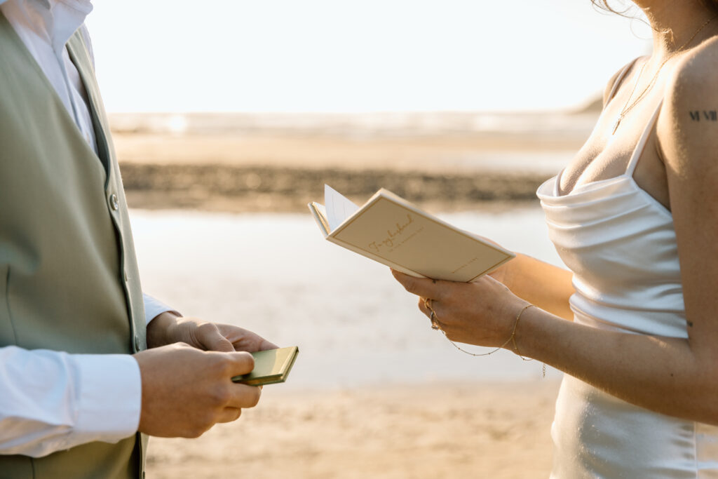 Close up of vow books while bride is saying vows.