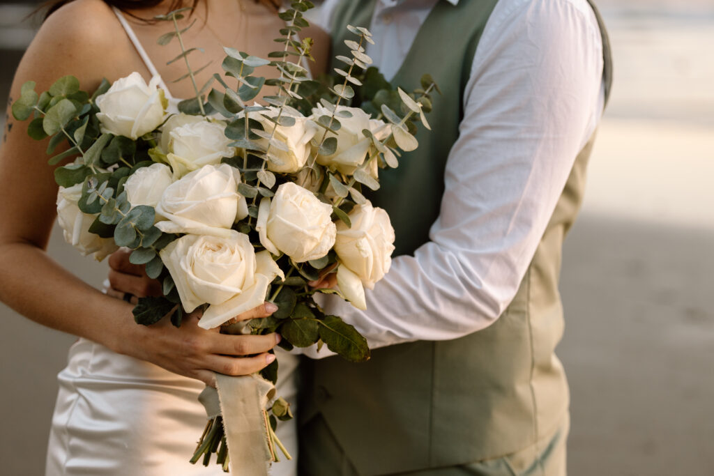 Close up of bride's bouquet of roses and eucalyptus.
