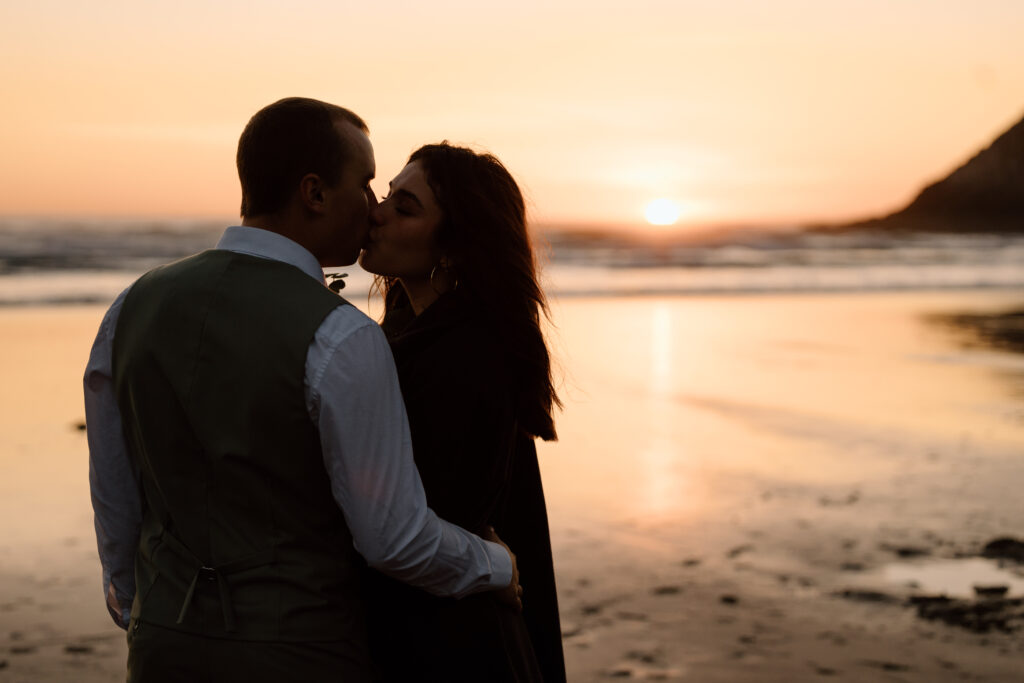 Couple kissing as the sun sets.